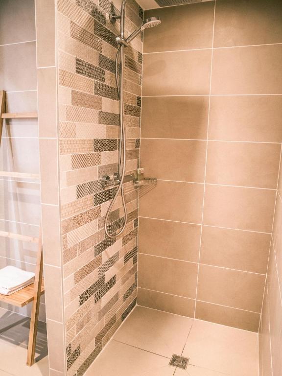 a bathroom with a shower with a glass door at Best Western Plus Antibes Riviera in Antibes