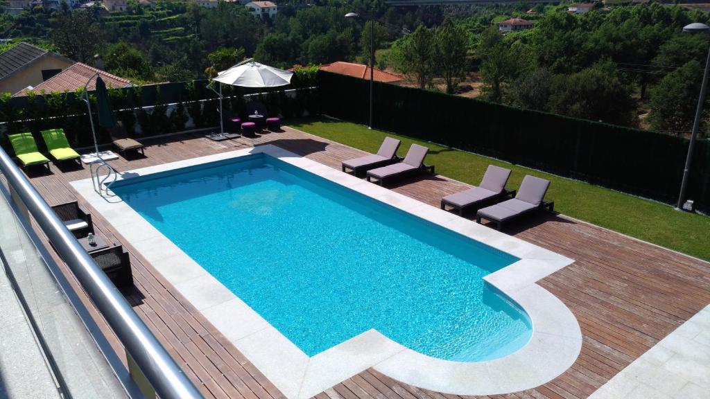 a swimming pool on top of a house at AboimHouse in Amarante