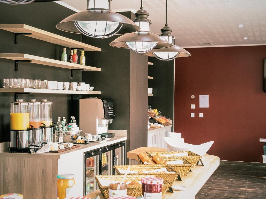 a kitchen with a counter with bread and other foods at Best Western Plus Antibes Riviera in Antibes