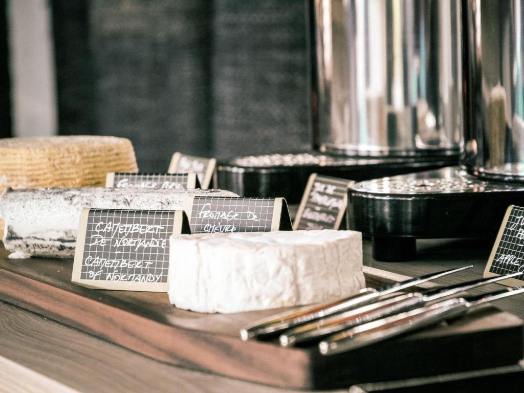 a table topped with a block of soap and silverware at Best Western Plus Antibes Riviera in Antibes