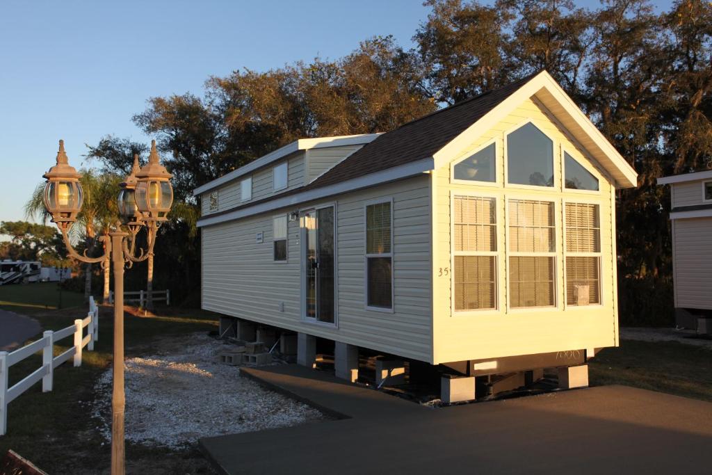 a tiny house sitting on top of a driveway at Orlando RV Resort in Orlando