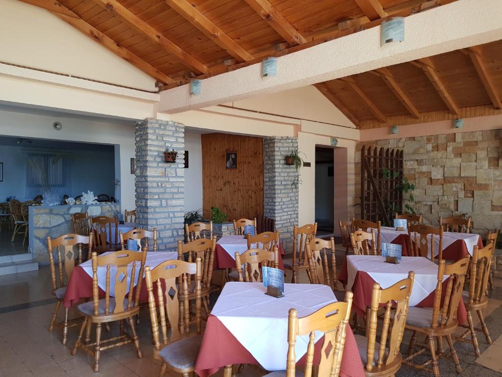 a restaurant with tables and chairs in a building at Bed and Breakfast MIRAMAR in Starigrad