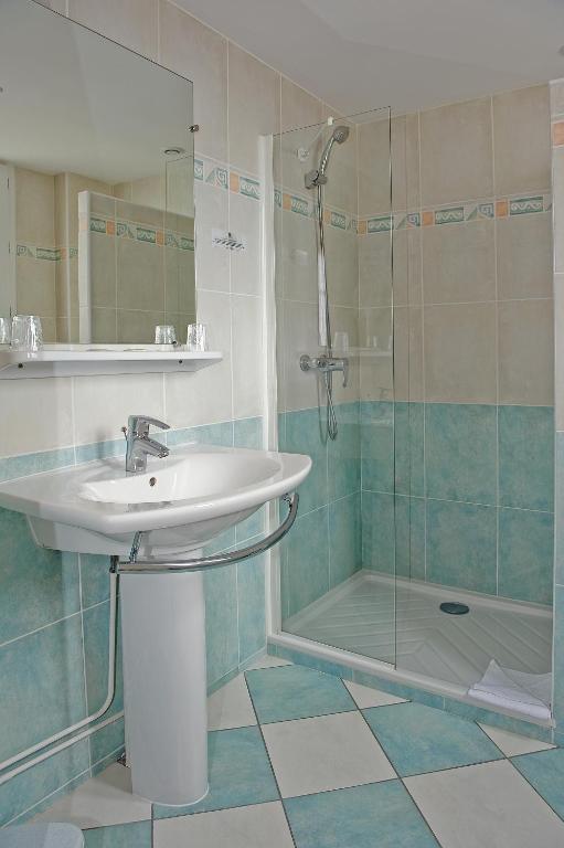 a bathroom with a sink and a shower at Logis Hôtel Des Châteaux De La Loire in Tours