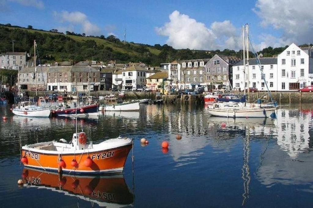 a group of boats are docked in a harbor at TopHeavy Cottage Mevagissey in Mevagissey