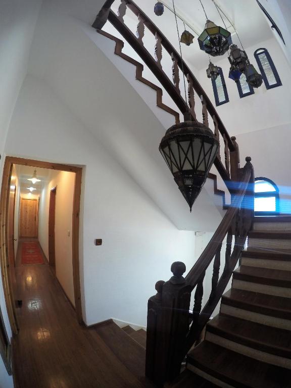 a person walking down the stairs in a house at logis la marine in Sidi Ifni