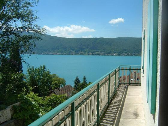 a view of a lake from a balcony of a building at Villa le Lac - Cottage au bord du Lac d' Annecy - chambres - in Veyrier-du-Lac