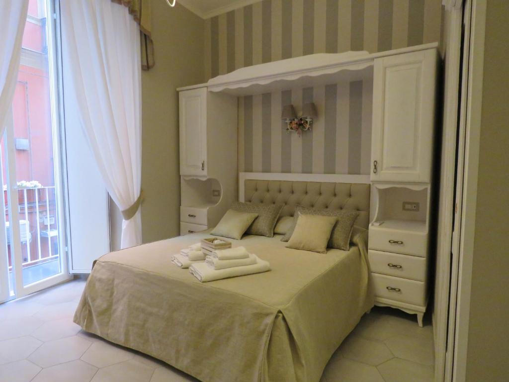 a bedroom with a bed with two towels on it at Le Ninfe Luxury Rooms in Naples