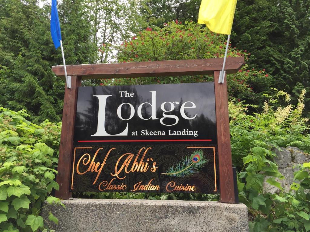a sign for the lodge at the disney gardens at The Lodge At Skeena Landing in Terrace