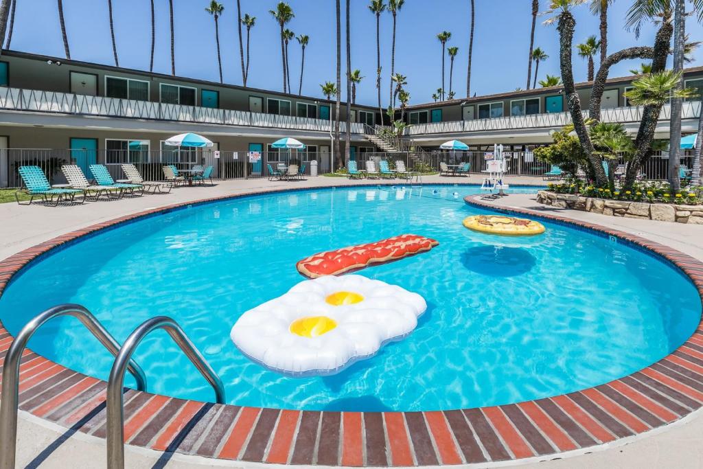 a pool at a resort with two inflatables at Kings Inn in San Diego