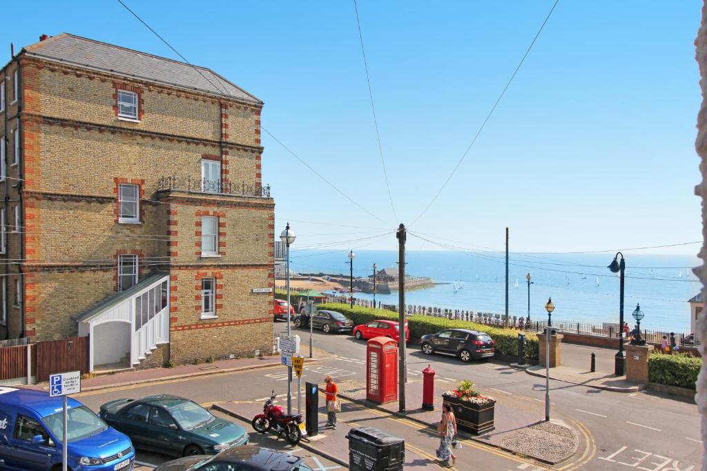 a street with a brick building and a red phone booth at Ocean Outlook - Broadstairs Best! in Broadstairs