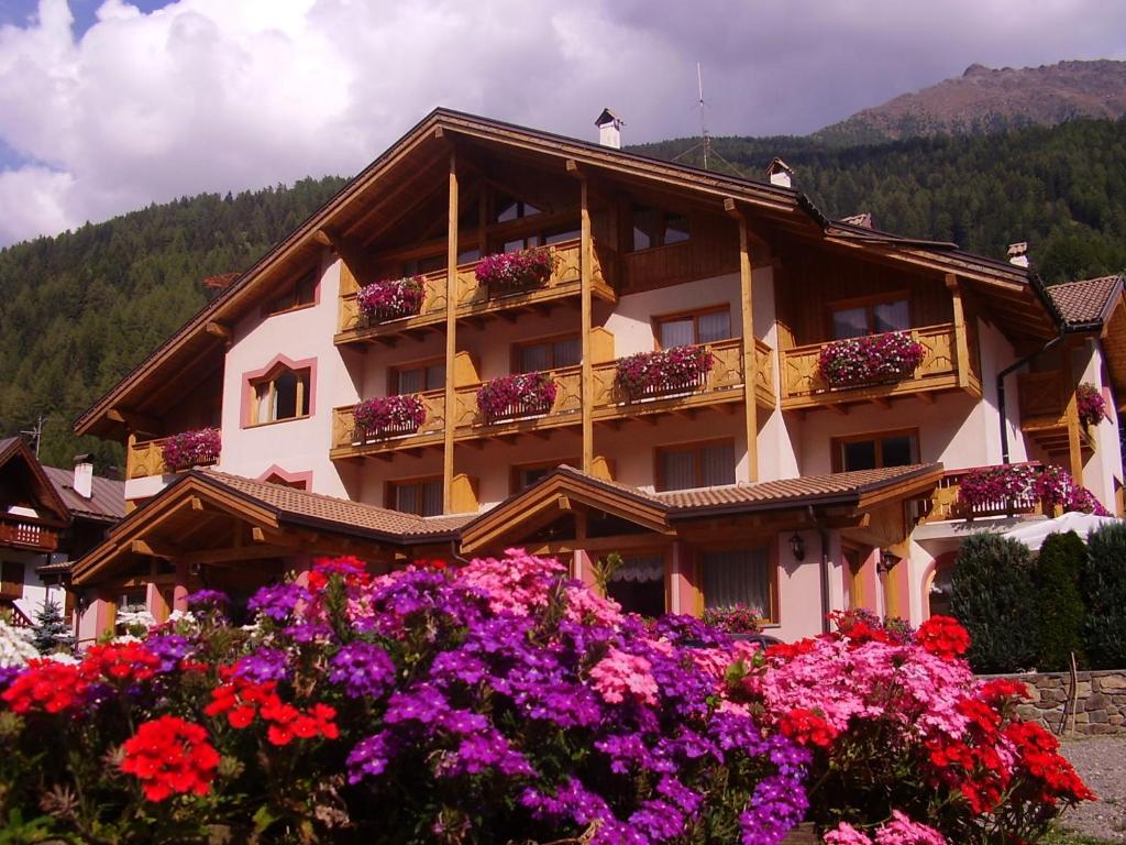 a building with flowers in front of it at Active Hotel Gran Zebru' in Cogolo