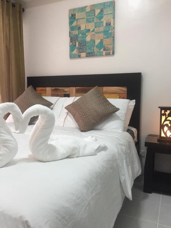 a bed with two swans made to look like hearts at AAA Condominium in Tagaytay