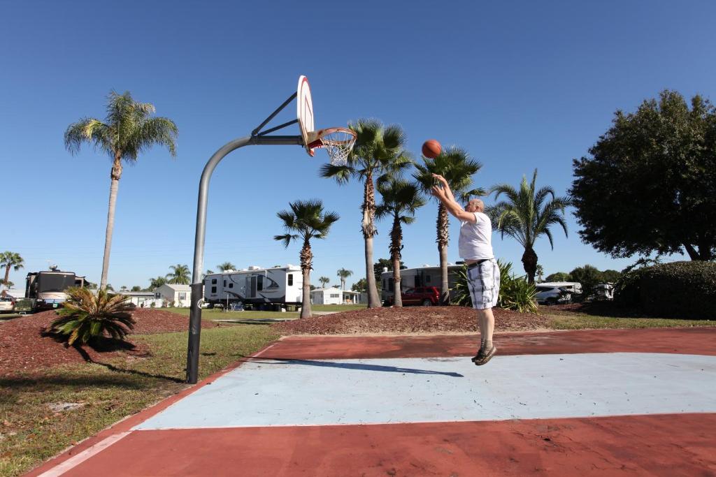 a man dunking a basketball in a hoop at Orlando RV Resort in Orlando