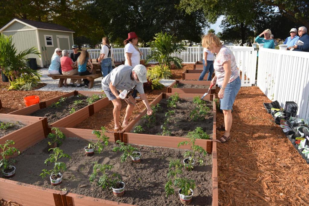 a group of people working in a garden at Orlando RV Resort in Orlando