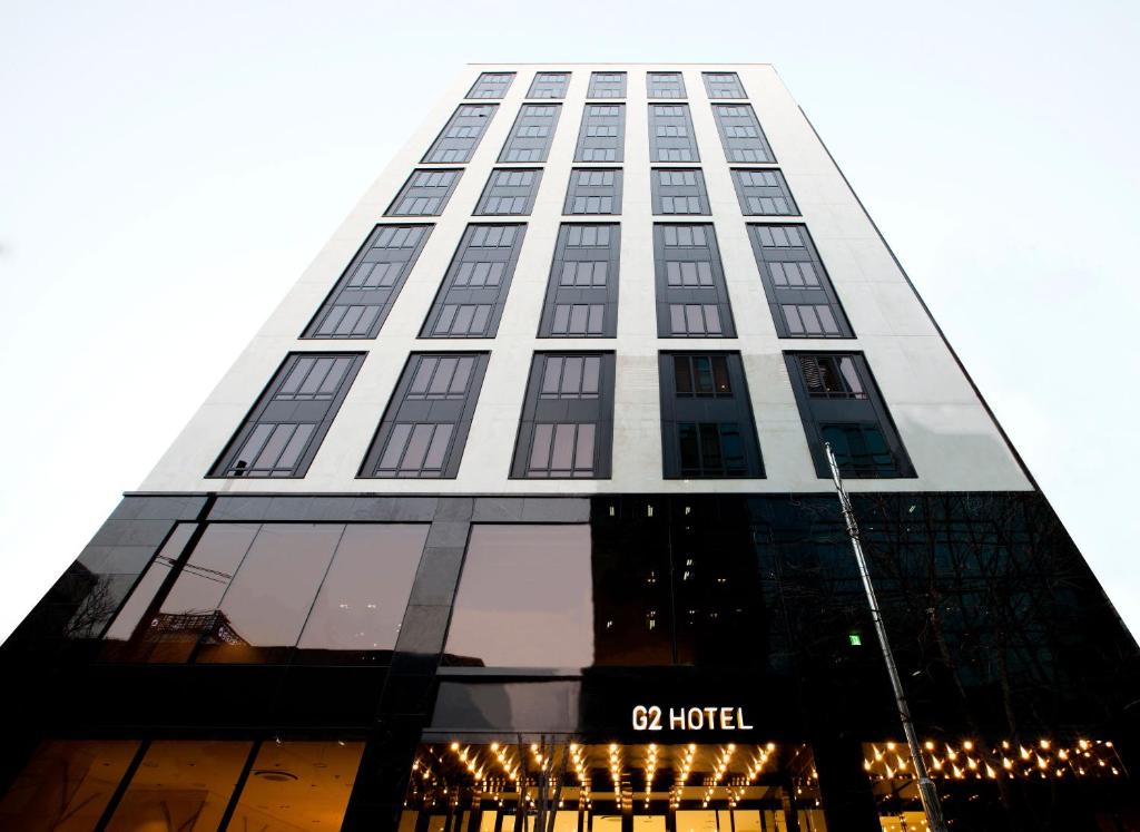 a tall building with a lot of windows at G2 Hotel Myeongdong in Seoul