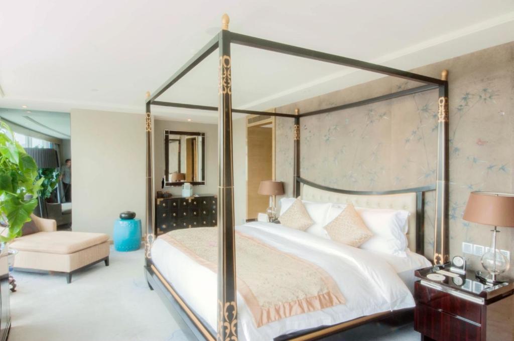 Postel nebo postele na pokoji v ubytování Tangla Hotel Tianjin