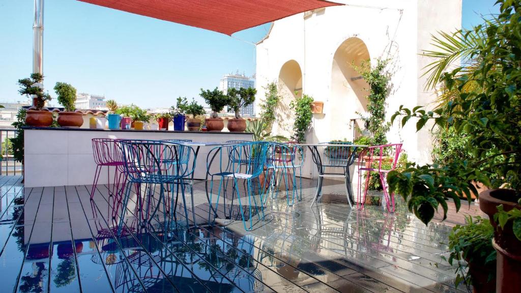 a patio with chairs and a table on a balcony at B&B Attico Partenopeo in Naples