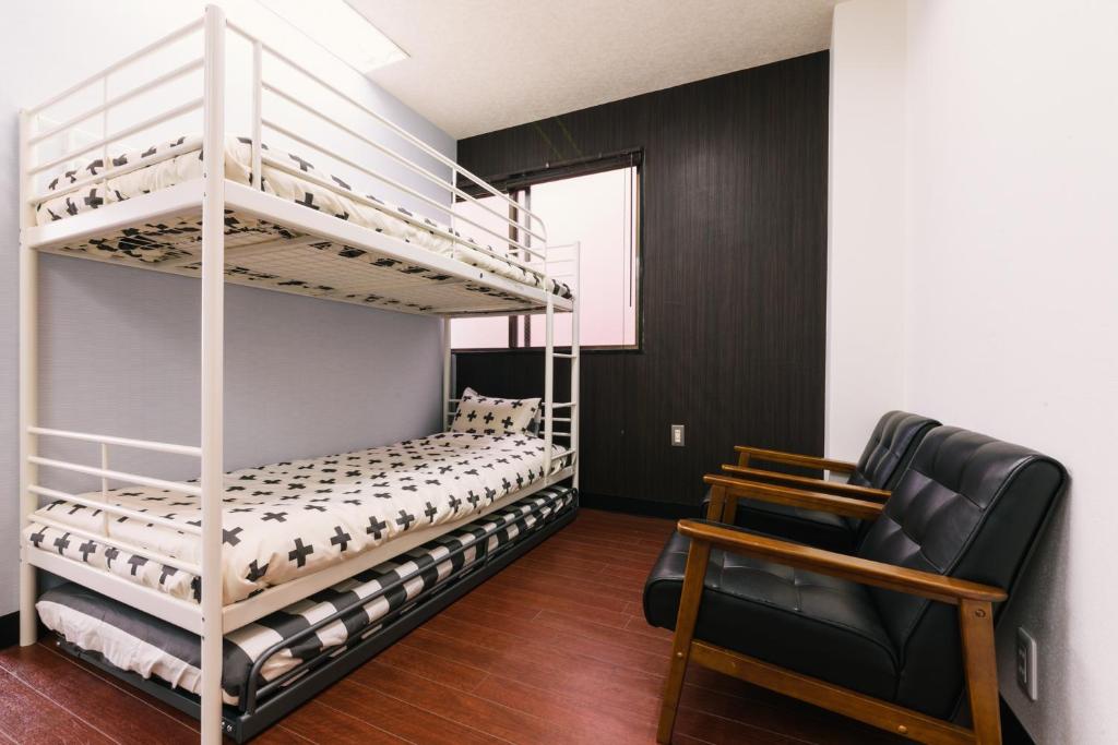 Postel nebo postele na pokoji v ubytování Guest House Yasuragi Hakataekimae