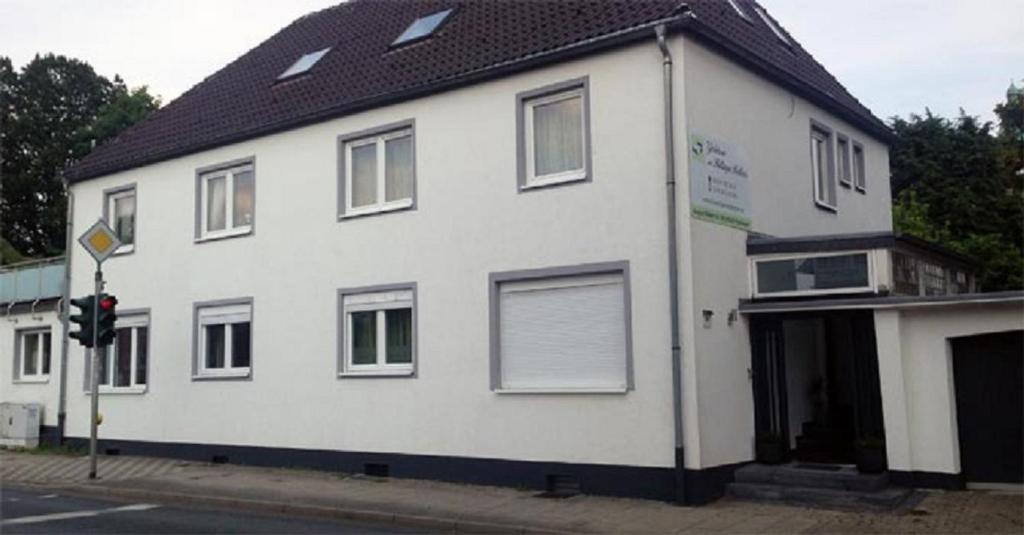 a white building on the corner of a street at Gästehaus am Hattinger Rathaus in Hattingen