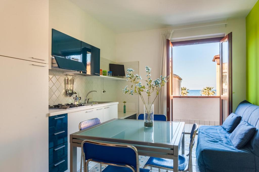 a kitchen and living room with a table and a couch at Settessenze Residence & Rooms in Agropoli