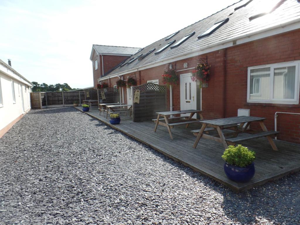 a patio with picnic tables on a house at Pay2Stay in Chester