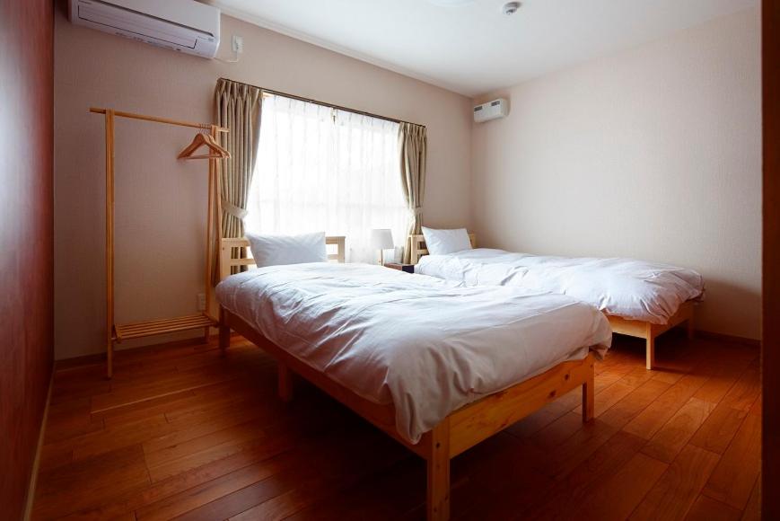Postel nebo postele na pokoji v ubytování 宿屋 天空
