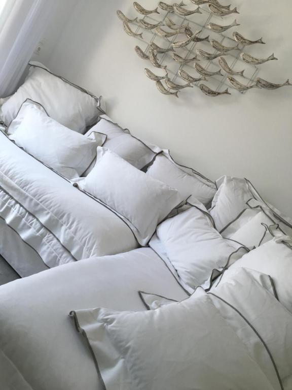 a white couch with pillows in a room at Nea Stira Studios Kondilia in Nea Stira