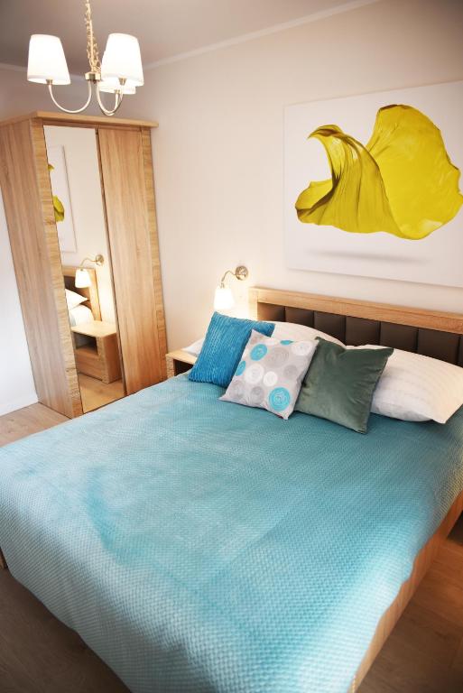 Posteľ alebo postele v izbe v ubytovaní Apartament Szmaragdowy