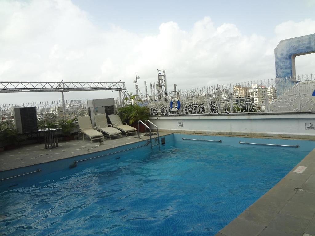 a swimming pool on the roof of a building at Ramee Guestline Hotel Juhu in Mumbai