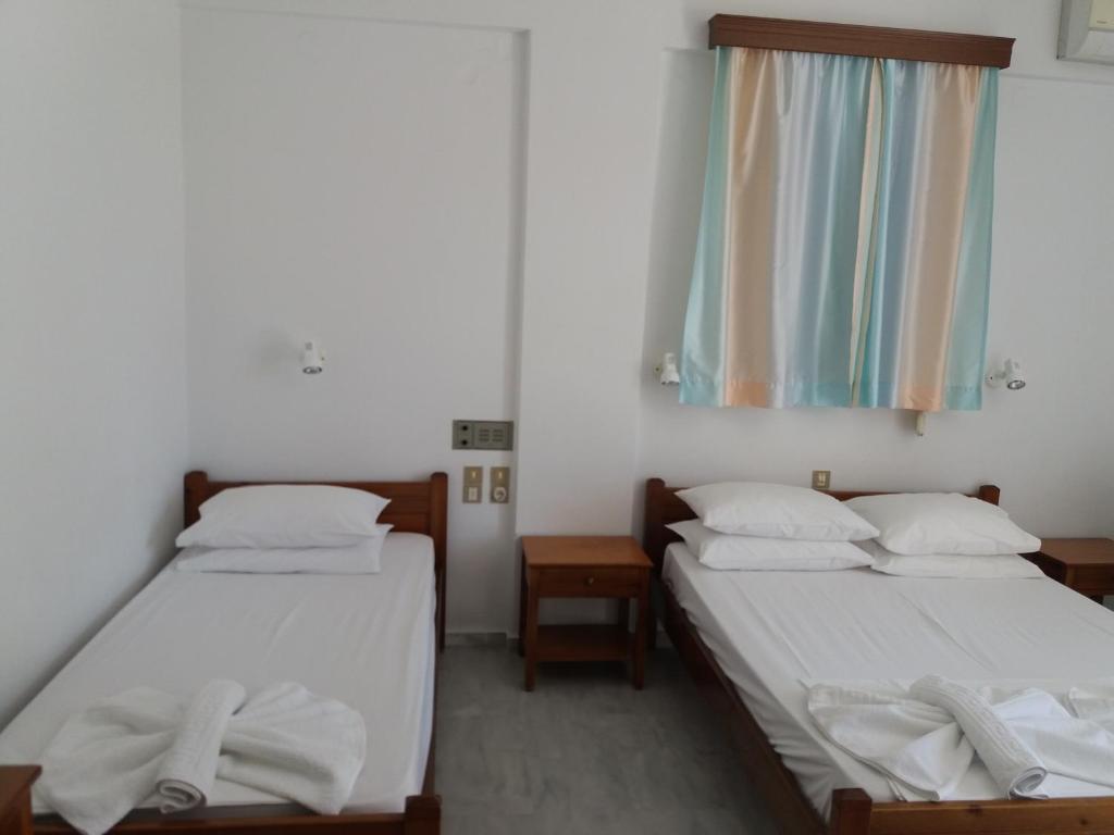 Postel nebo postele na pokoji v ubytování Heracles Hotel