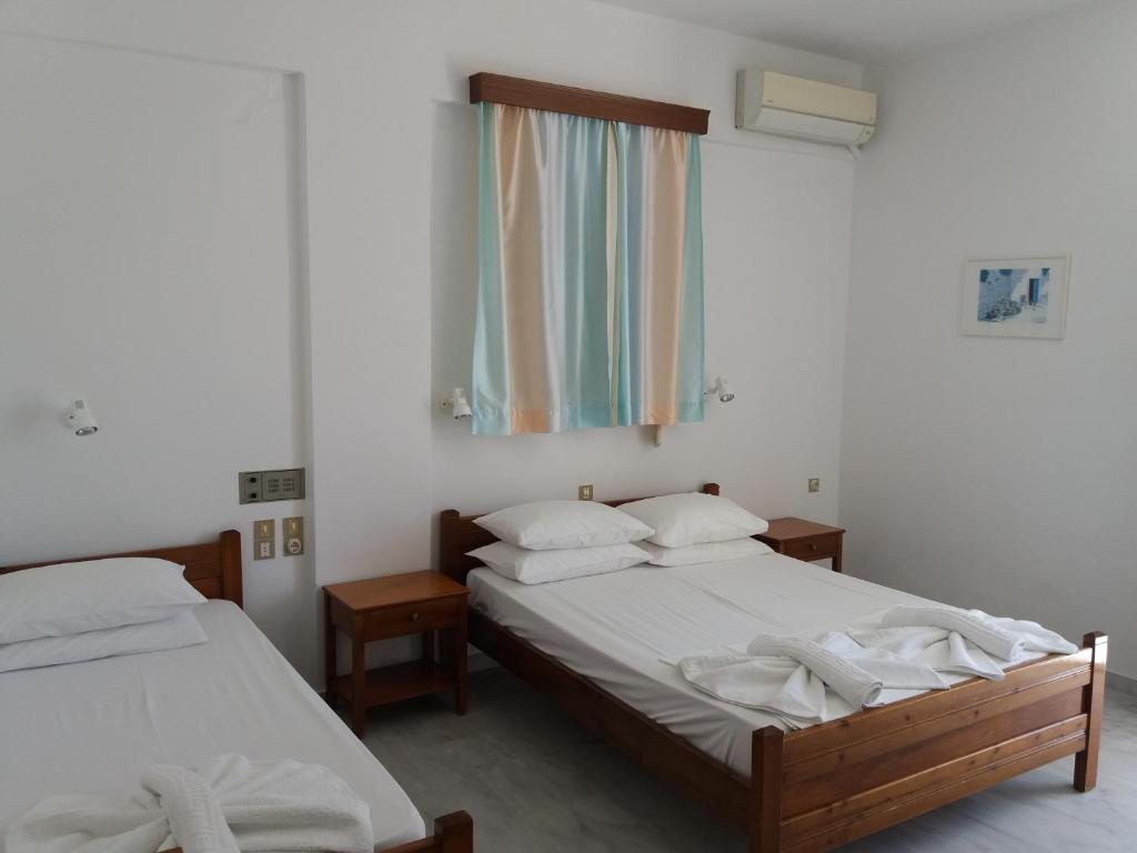 Postel nebo postele na pokoji v ubytování Heracles Hotel