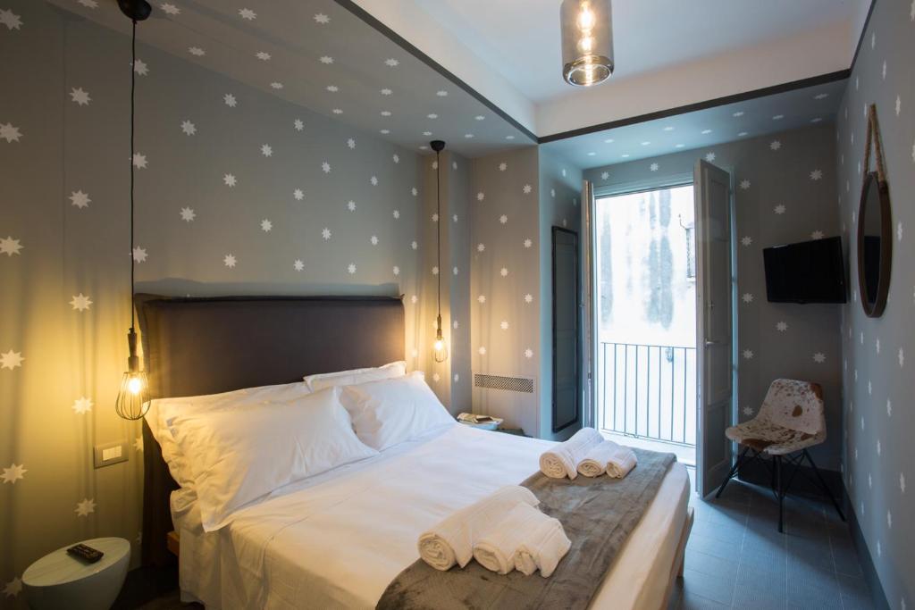 Postel nebo postele na pokoji v ubytování Intervallo Boutique Hotel