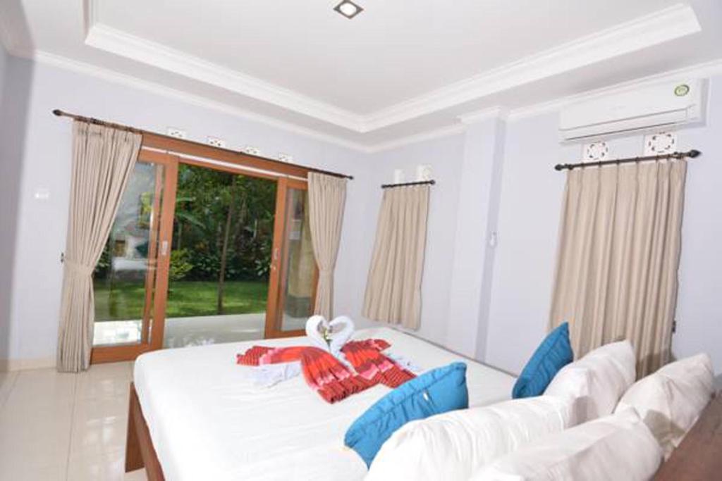 Postel nebo postele na pokoji v ubytování Artja Inn Ubud