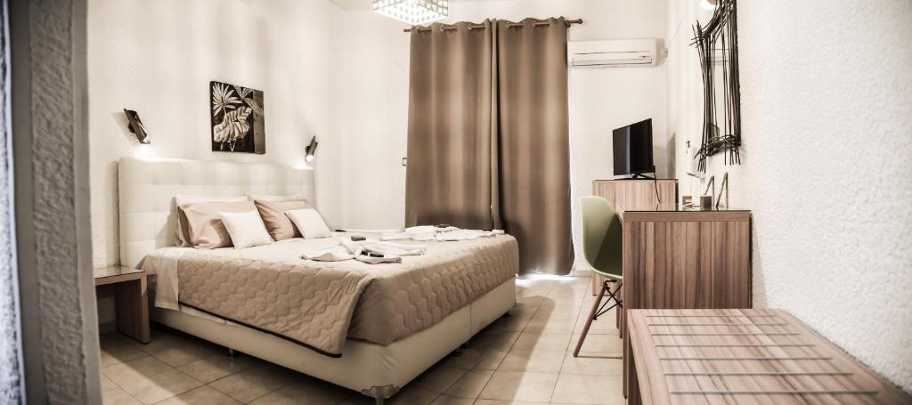 Postel nebo postele na pokoji v ubytování Vallian Village Hotel