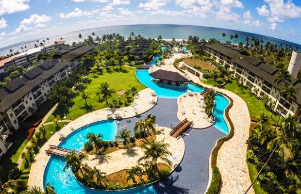 an aerial view of a resort with two water slides at Flat Beach Class Muro Alto 4307 in Porto De Galinhas
