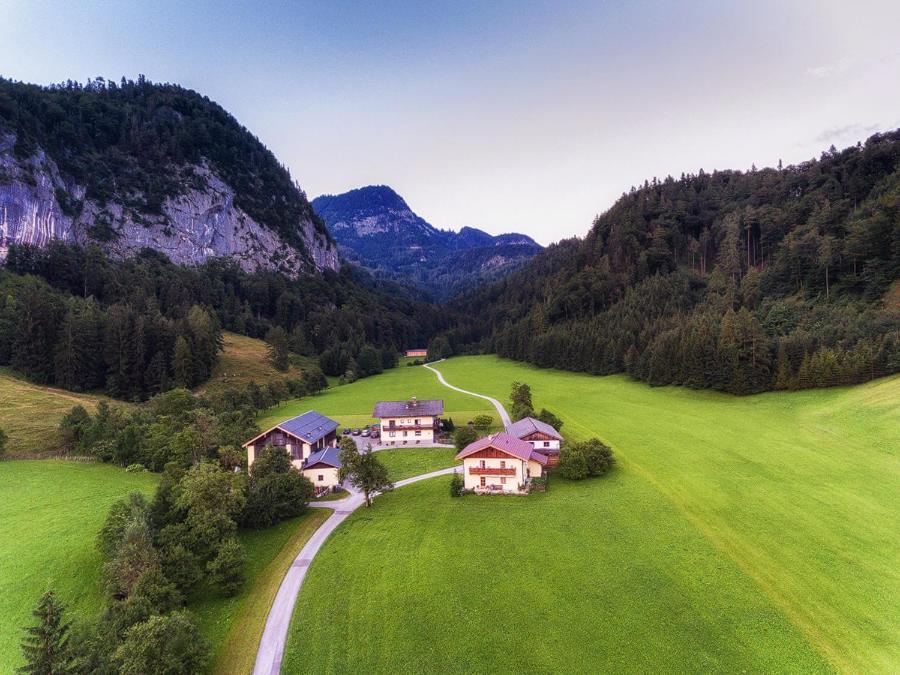 an aerial view of a house in a green field at Hinterkellaubauer in Kuchl