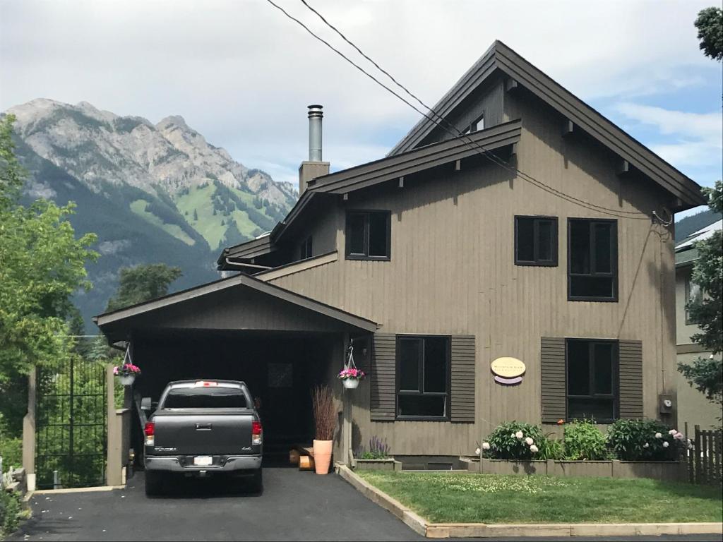 a truck parked in front of a house with a mountain at Mountain View Bed & Breakfast in Banff