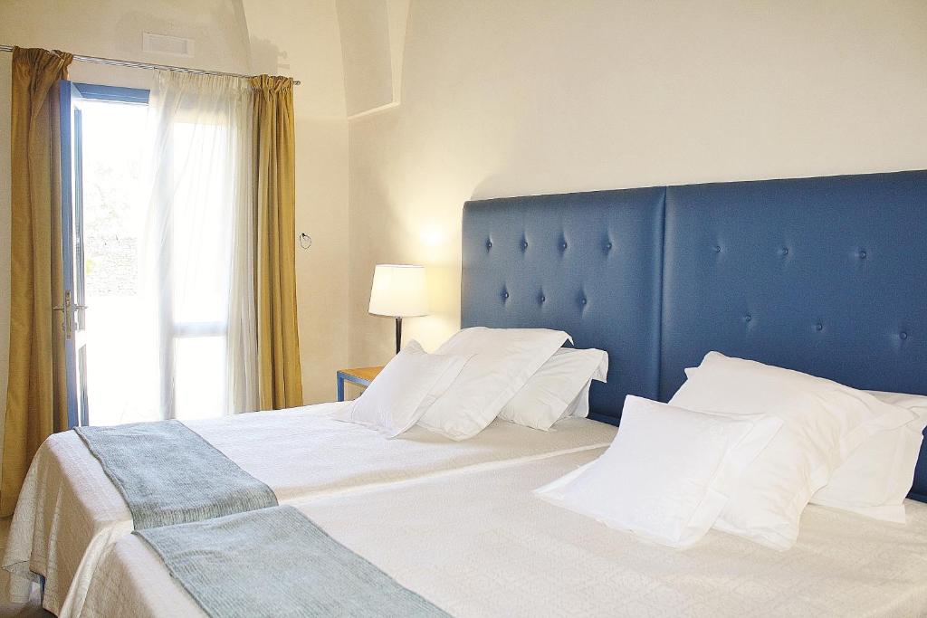 Postel nebo postele na pokoji v ubytování Antica Masseria Torre Mozza