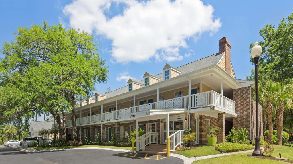 a large house with a balcony on a street at Best Western Plus St. Simons in Saint Simons Island