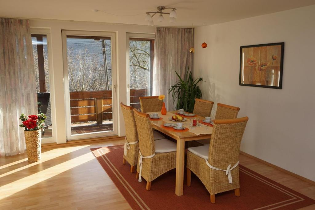 a dining room with a wooden table and chairs at Ferienwohnung-Jungbauernhof in Alpirsbach