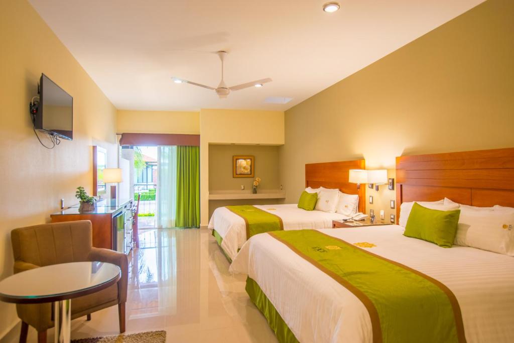 Postel nebo postele na pokoji v ubytování Hotel Ecce Inn & Spa