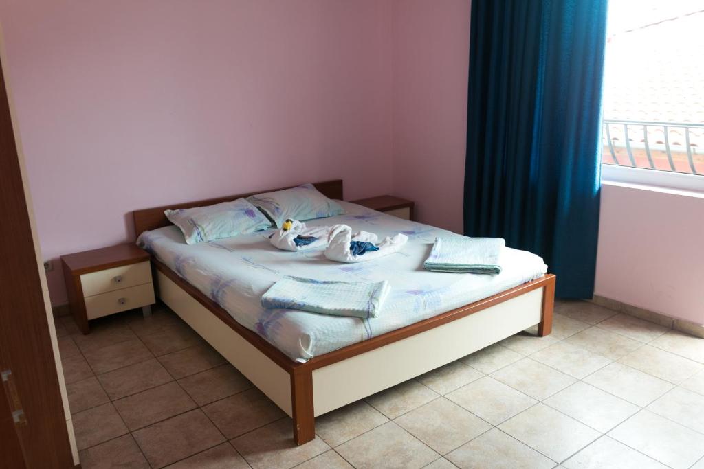 a bedroom with two swans on a bed with a window at Sea House Guest House in Nesebar