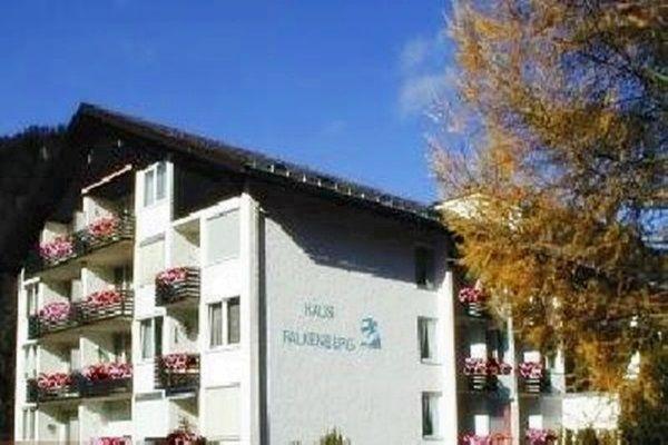 a large white apartment building with flowers on the balconies at Falkenberg-Wohnung-201 in Oberstdorf