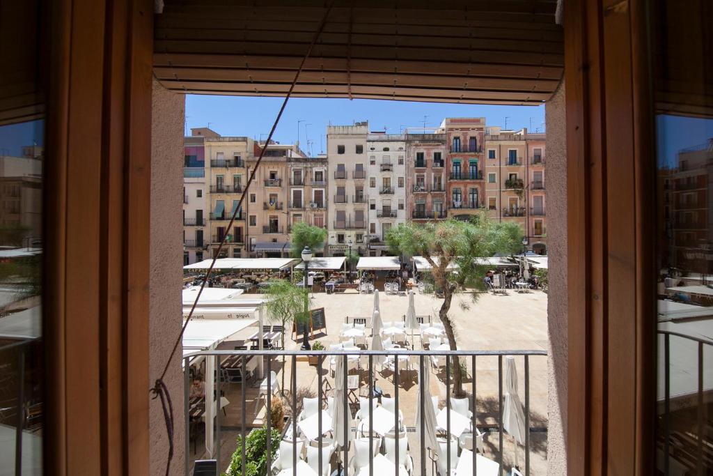 a view of a city from a window at El Faro Apartaments in Tarragona