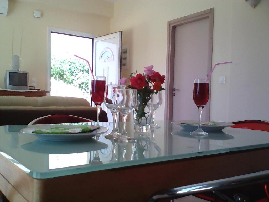 スタブロスにあるDemi's houseのワインと花のテーブル