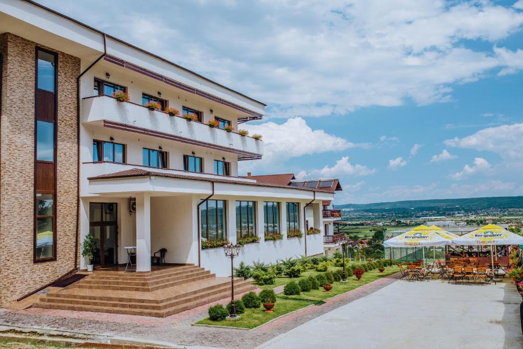 a view of a building with a patio at Pensiunea Diana in Argeşelu