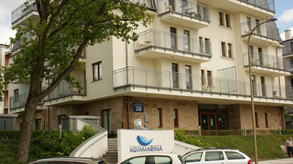 a building with cars parked in front of it at Apartament Magdalena in Świnoujście