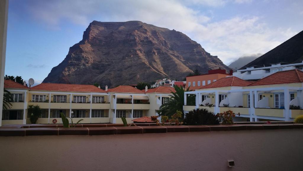 a mountain in the background of a town with buildings at Apartamentos Ferpa in Valle Gran Rey