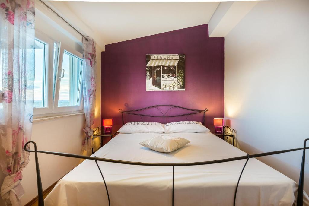 Posteľ alebo postele v izbe v ubytovaní Apartmani Maksan
