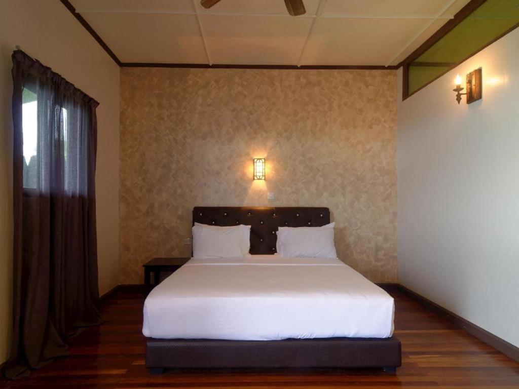 Postel nebo postele na pokoji v ubytování Kasih Sayang Hill Resort